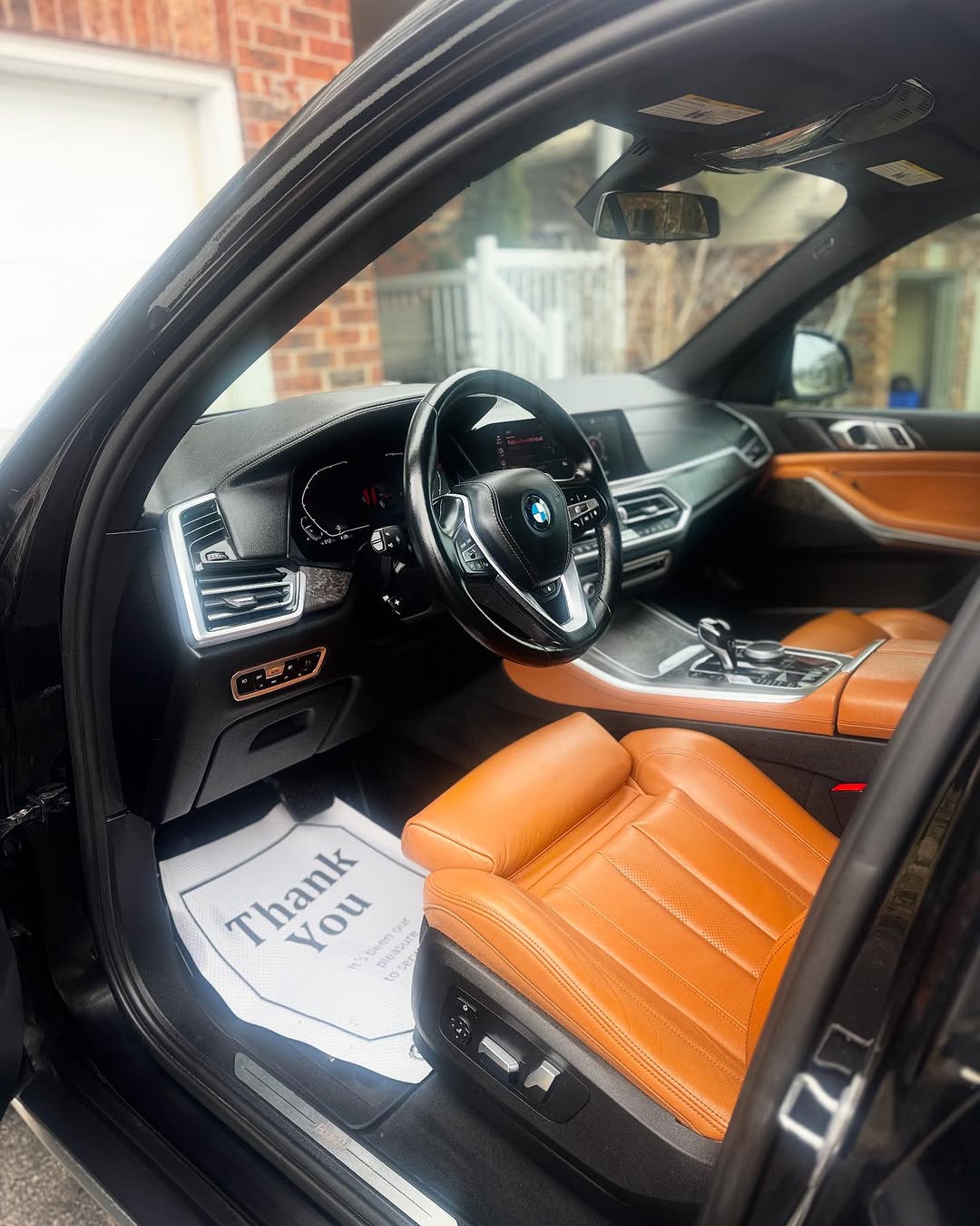 BMW X5 interior with tan leather seats after detailing by Jana Mobile Detailing